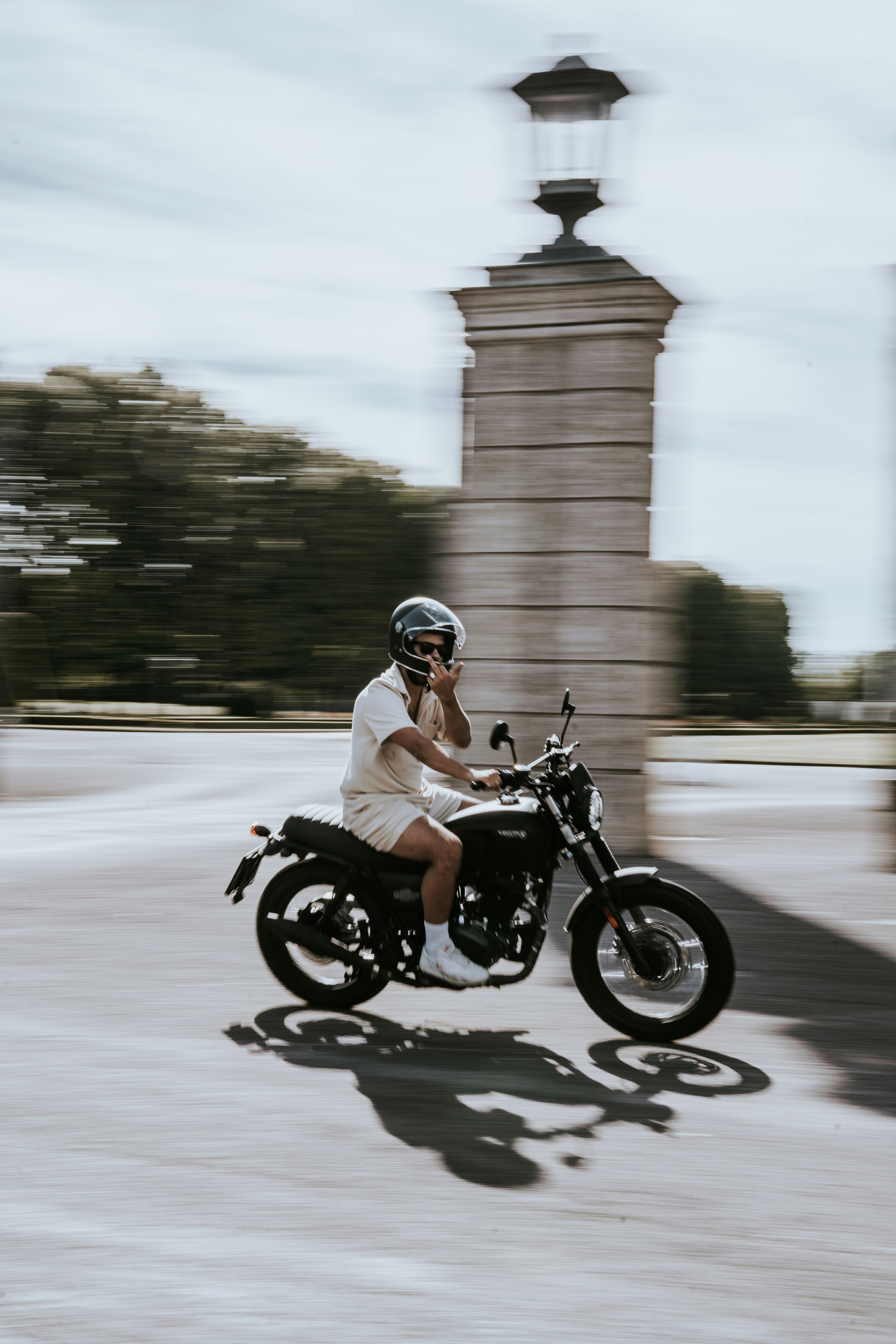 man in black helmet riding motorcycle on road during daytime